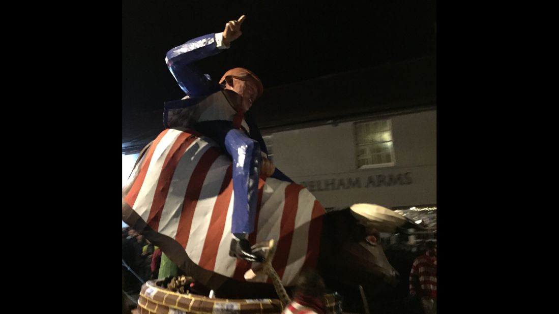 An effigy of Trump riding a bucking bull draped in the Stars and Stripes is paraded down the street in Lewes on November 5.