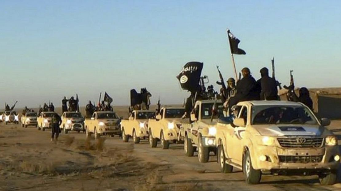ISIS militants ride through Raqqa, Syria. 