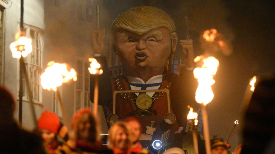 Thousands of people line the narrow streets of Lewes to watch the bonfire societies parade past with their effigies in a torch-lit procession. Here another incarnation of Trump is seen.
