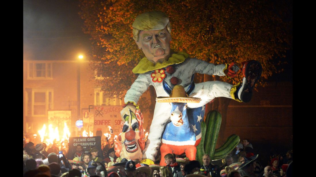 An effigy of Trump dressed as a clown riding a donkey is paraded down the street on November 5 in Lewes. After the procession, the crowds -- and their giant effigies -- disperse toward several separate bonfire parties, where the figures are blown apart by fireworks.