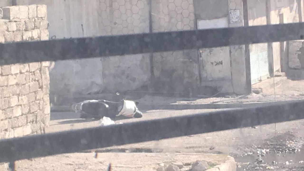 A motorcycle lays abandoned on the ground. The driver jumped from it while it was still moving and ran away.