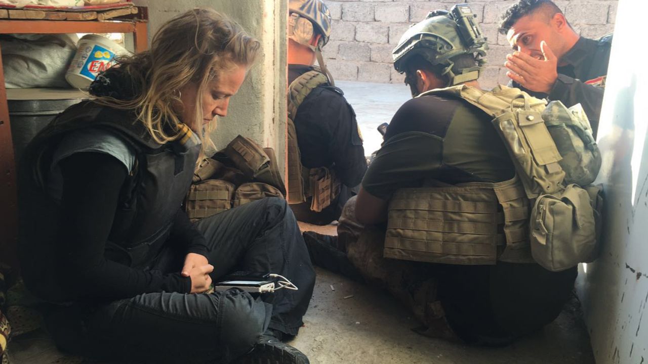 Arwa and the team sit while waiting for backup.