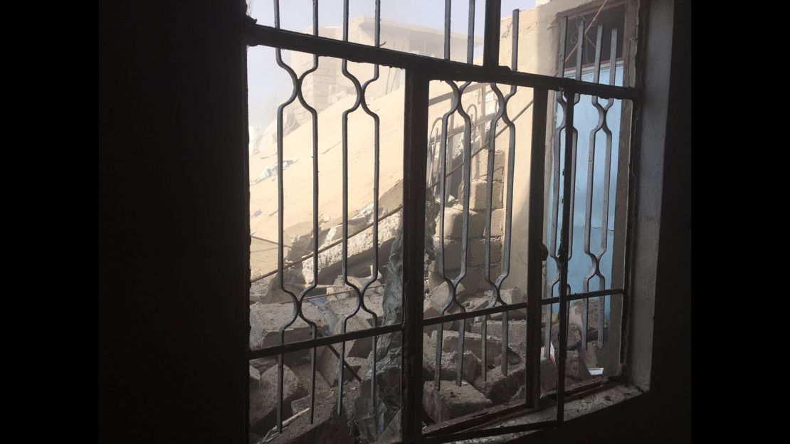 Rubble is seen through a window. An airstrike took out the house behind the one in which Arwa and Brice were staying.
