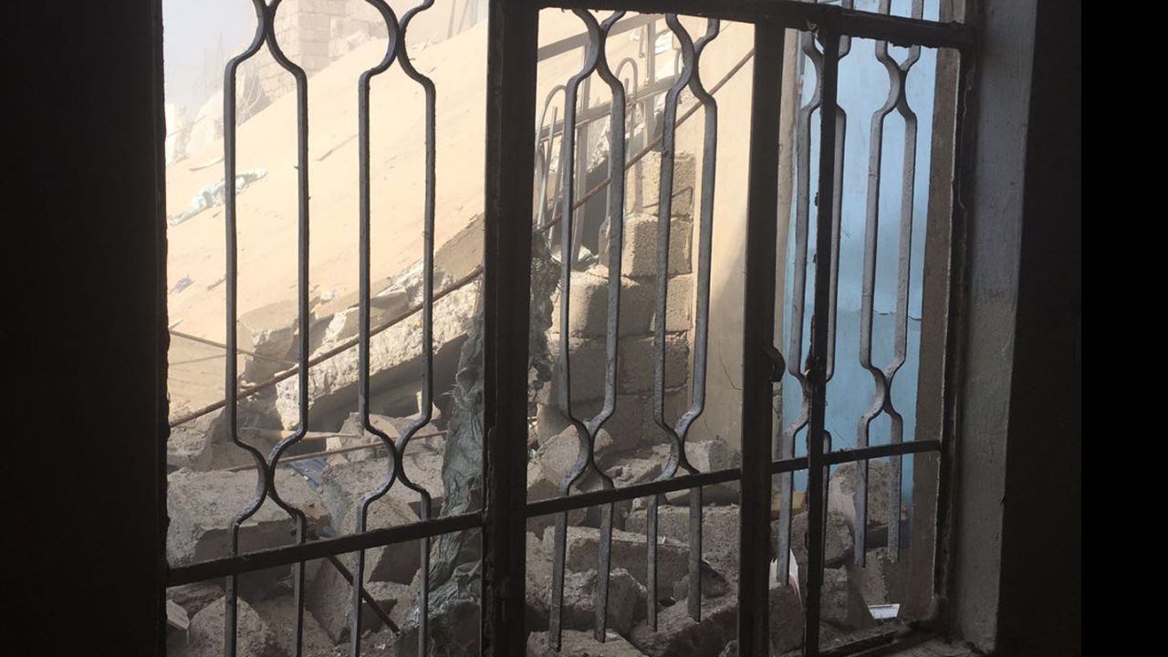 Rubble is seen through a window. An airstrike took out the house behind the one in which Arwa and Brice were staying.