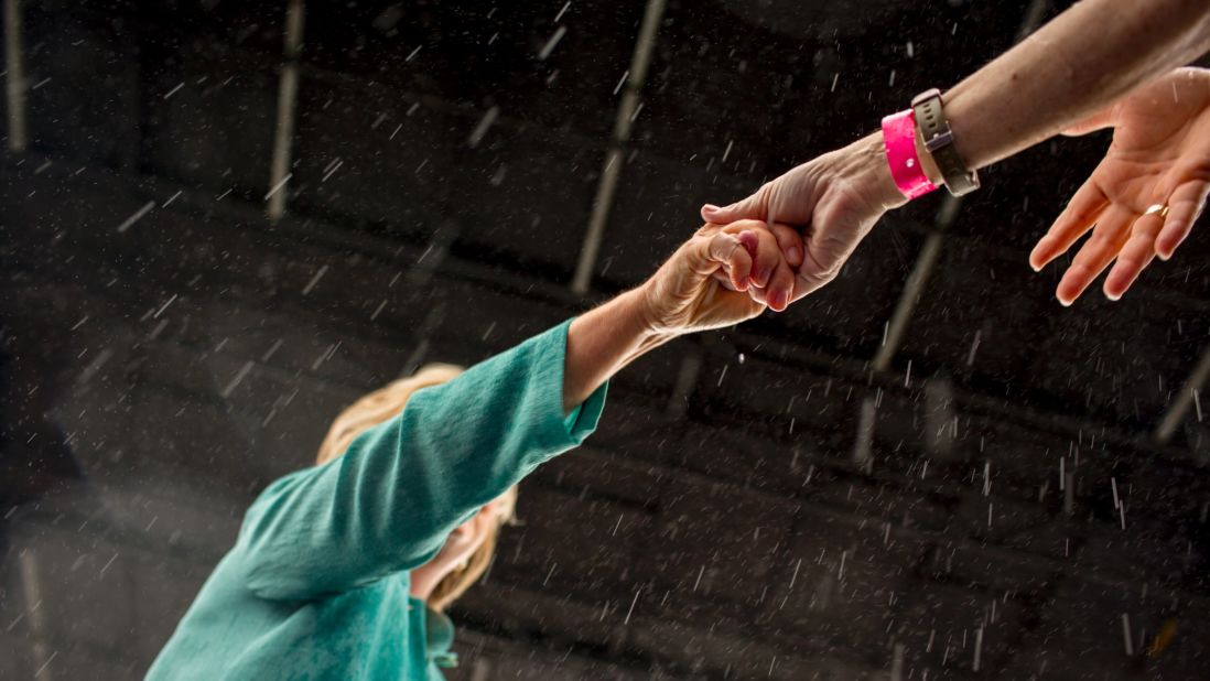 Clinton shakes hands with supporters during a rainstorm in Miami on Saturday, November 5.