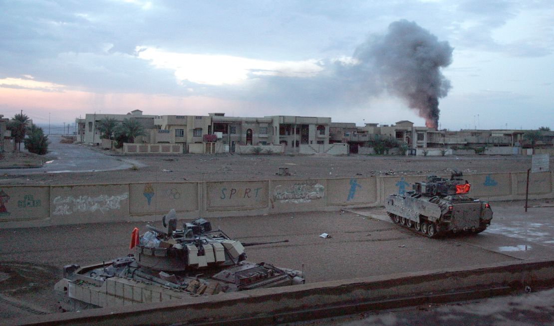 US Bradley fighting vehicles hold a position inside a schoolyard during heavy fighting in Falluja in 2004