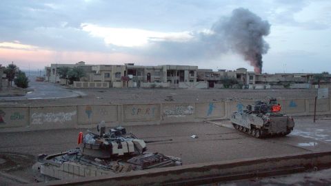 US Bradley fighting vehicles hold a position inside a schoolyard during heavy fighting in Falluja in 2004