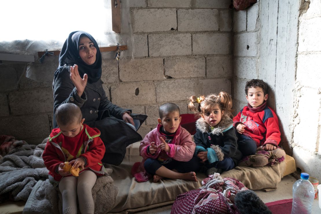 Rana is raising four children, aged 4 to 6, in a small two-bedroom apartment in an unfinished building in Damascus.