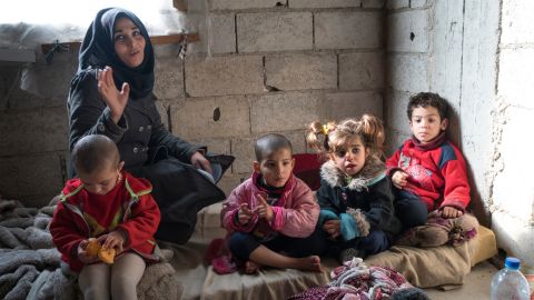 Rana is raising four children, aged 4 to 6, in a small two-bedroom apartment in an unfinished building in Damascus.
