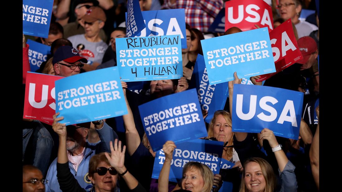Clinton supporters hold signs in Cleveland on November 6.
