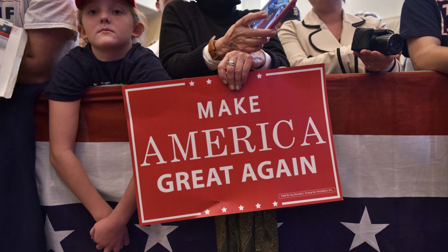 Supporters hold placards during a rally for US Republican presidential nominee Donald Trump at the Atkinson Country Club in Atkinson, New Hampshire on November 4, 2016. / AFP / MANDEL NGAN        (Photo credit should read MANDEL NGAN/AFP/Getty Images)