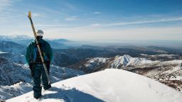 Skier standing on a peak at Oukaimeden resort in the Atlas mountains.
