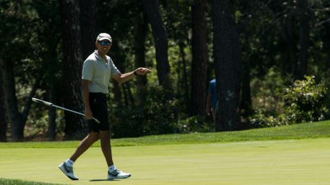 Obama reacts to his putt on the first green at Farm Neck Golf Club on Martha's Vineyard on August 7, 2016.