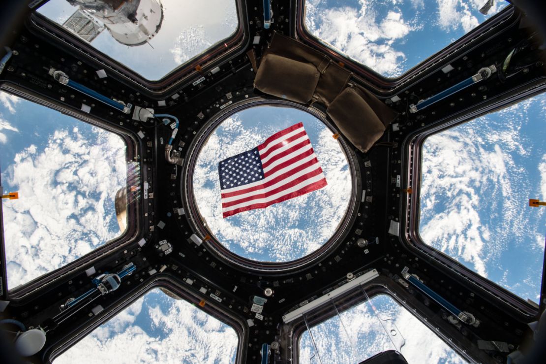 Image Kjell Lindgren released on social media of the US flag floating in the Cupola module. 