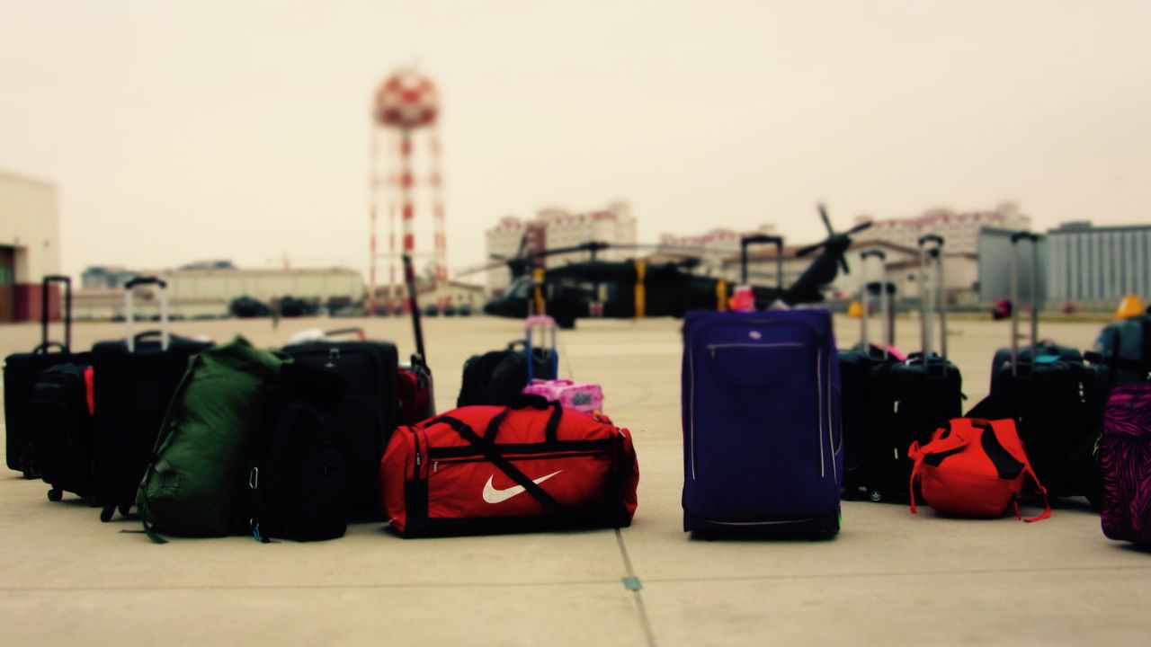 Bags sit on the runway in South Korea. Families have to carry food and water with them as well as personal items.