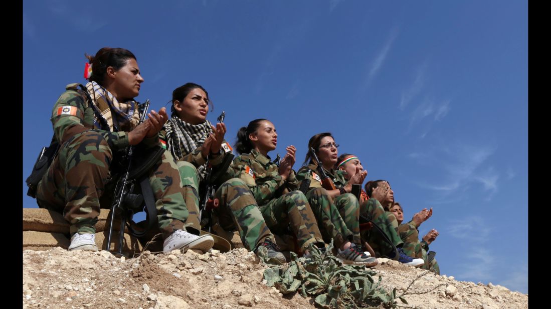 Female members of the Freedom Party of Kurdistan sing as they hold a position near Bashiqa on November 6.