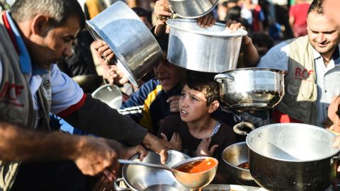 Displaced Iraqi boys wait for food at a refugee camp in Khazir near Mosul on November 5.