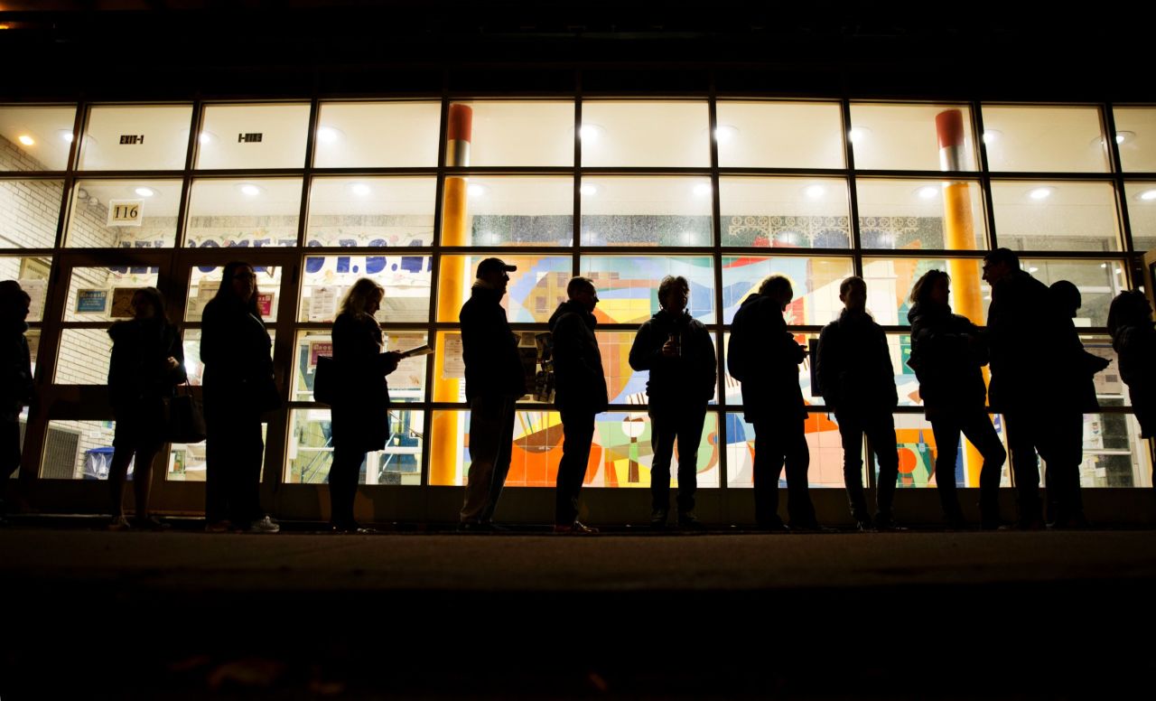 A line stretches down the street in New York as voters wait for a polling site to open.