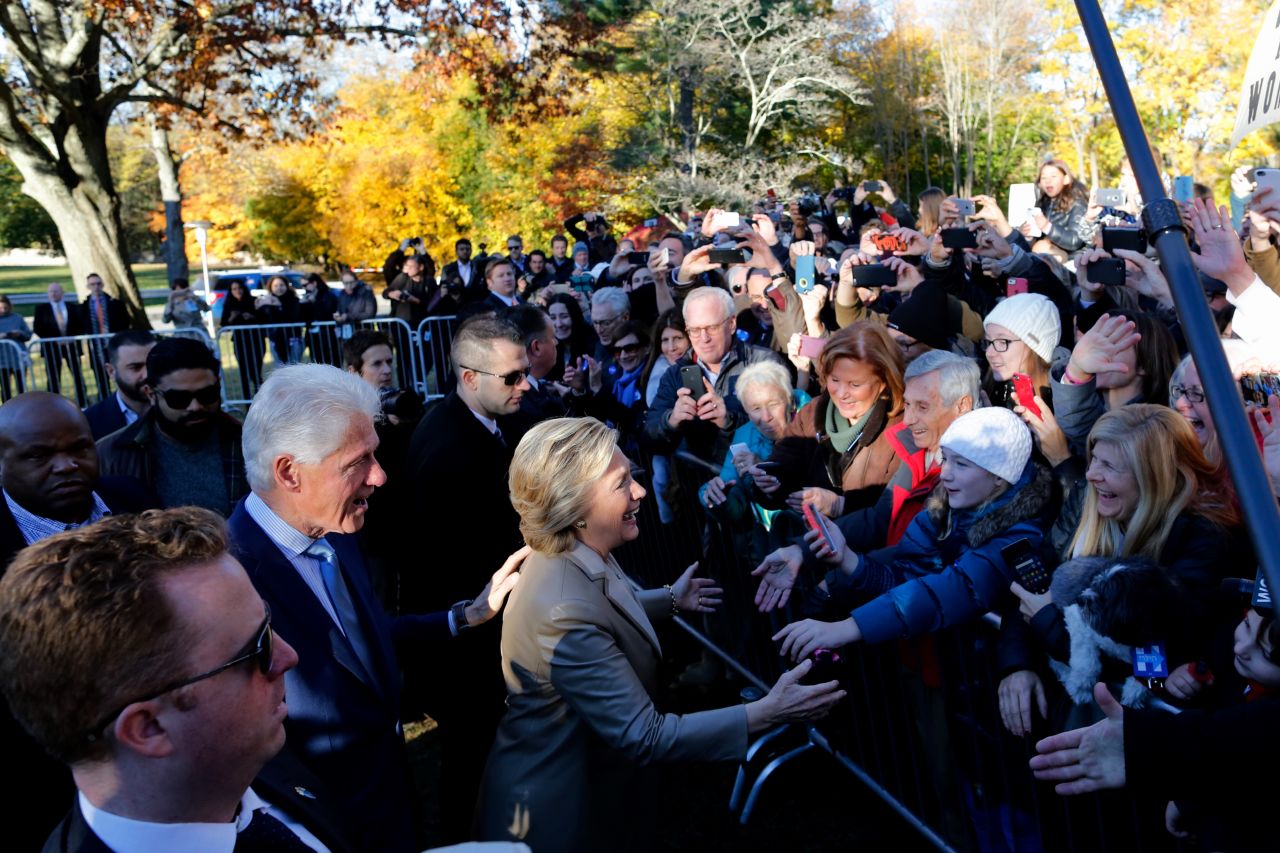 Democratic presidential nominee Hillary Clinton and her husband, former U.S. President Bill Clinton, greet supporters after voting in Chappaqua, New York.