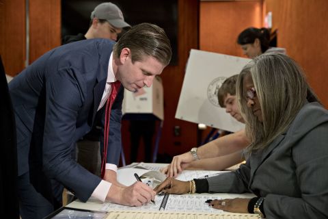 Trump's son Eric signs in to vote at the 53rd Street Library in New York.