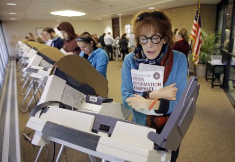 Kathleen Lundy eyes her ballot in Salt Lake City.