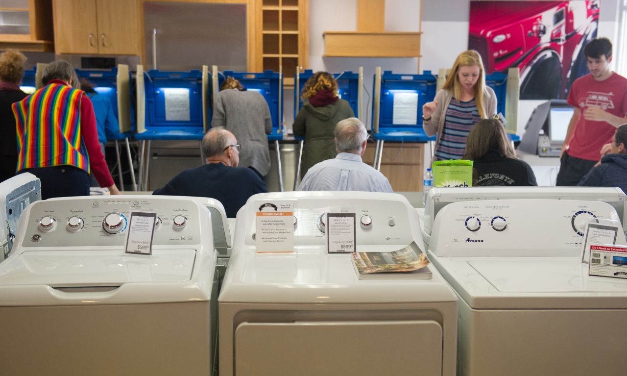 Voters cast their ballots in a polling location inside Mike's TV and Appliance November 8, 2016 in State College, Pennsylvania.