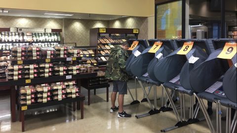 A man votes in the bakery department of an Austin, Texas, grocery store.