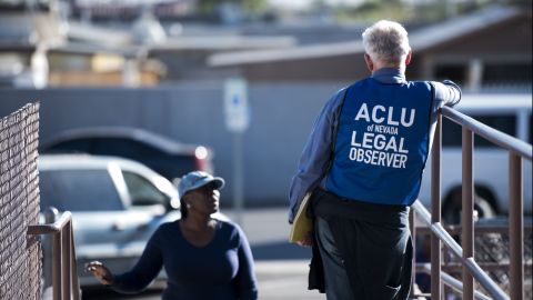 A legal observer with the American Civil Liberties Union of Nevada stands at the entrance of a polling location in North Las Vegas.