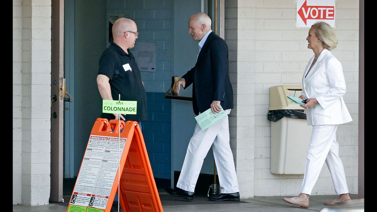 U.S. Sen. John McCain and his wife, Cindy, arrive at a polling place to cast their votes in Phoenix.