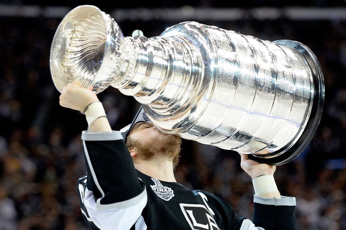 Dustin Brown of the Los Angeles Kings celebrates with the Stanley Cup in 2014.