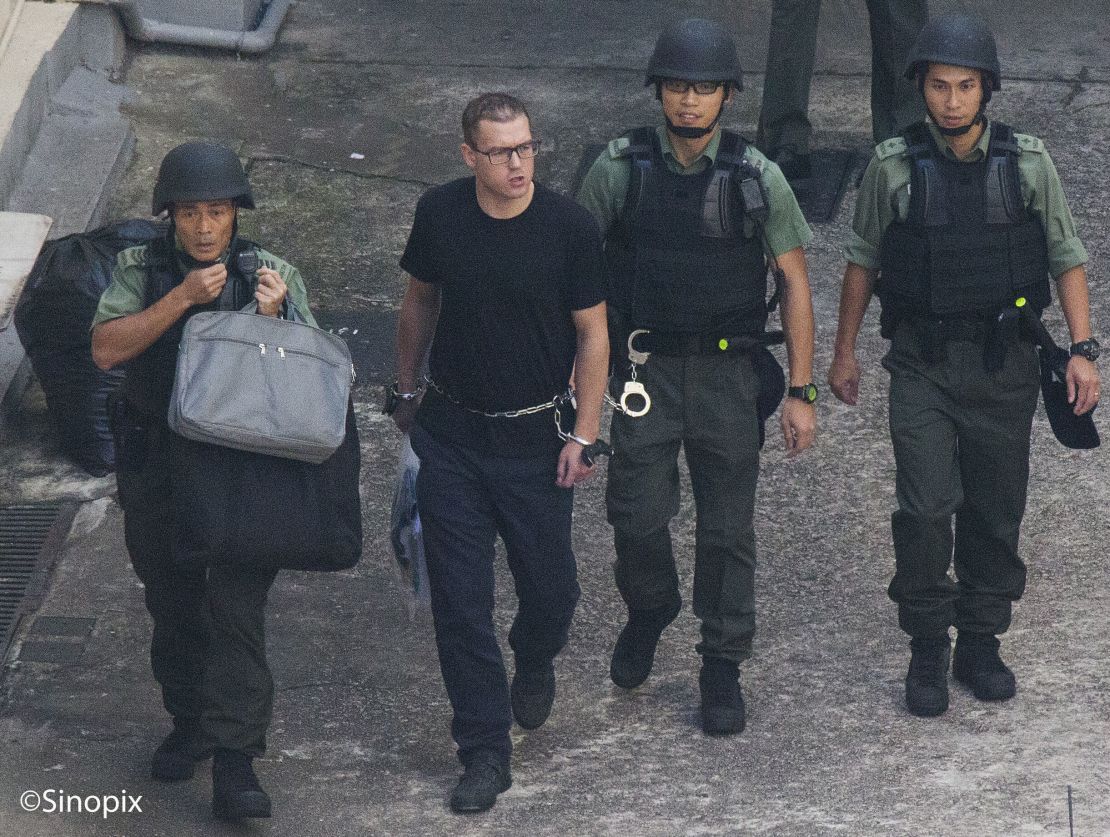 British ex-banker Rurik Jutting walks through a courtyard at the Lai Chi Kok Reception Centre shortly before boarding a high security prison van on 01 November 2016.