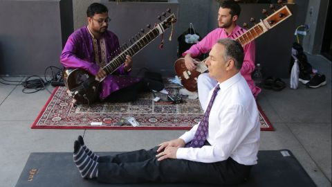 With sitar players performing next to him, Efrem Harkham meditates after voting at the Luxe Hotel polling station in Los Angeles.