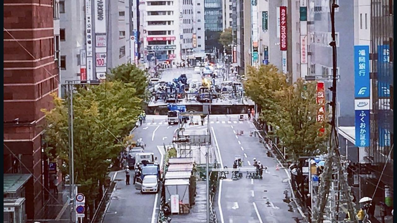 A giant sinkhole has opened up in Fukuoka, Japan, swallowing huge sections of road including traffic lights, near to underground work to extend a subway tunnel. Will Barker was close to Hakata Station and captured this image, showing emergency vehicles blocking access to the road. He told CNN: The hole was interesting, so I went to investigate.