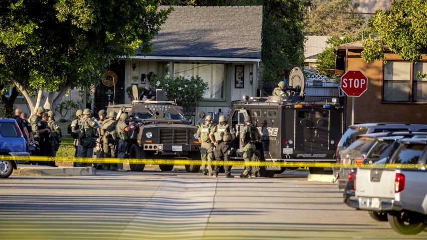 SWAT team moves in on a barricaded suspect on Fourth Street east of Orange Avenue after several people were shot at that location in Azusa, Calif., Tuesday, Nov. 8, 2016. The shooting occurred near a polling site; and elections officials say one other polling site was affected, urging voters to cast their ballots in other locations. Azusa police say arriving officers found multiple victims, came under fire and returned fire themselves. (Leo Jarzomb/San Gabriel Valley Tribune/SCNG via AP)