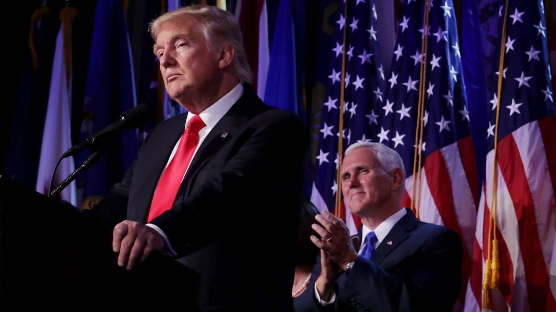 Republican president-elect Donald Trump delivers his acceptance speech as Vice president-elect Mike Pence looks on in the early morning hours of November 9, 2016.