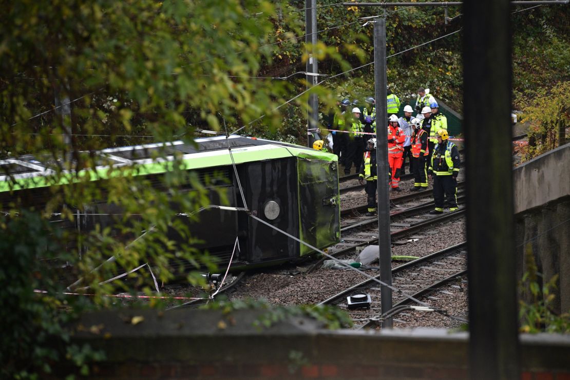 Emergency responders look at the overturned tram in Croydon, south London, on Wednesday.
