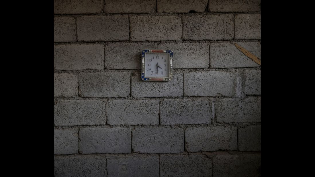 A small clock still hangs on the wall of an abandoned house on the outskirts of Mosul.