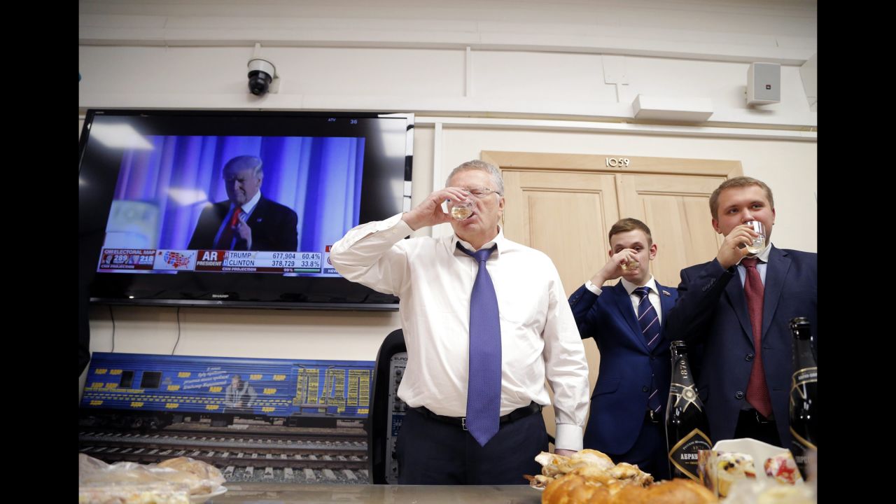 Vladimir Zhirinovsky, leader of the Liberal Democratic Party of Russia, left, toasts in front of a TV screening Trump's acceptance speech on November 9.
