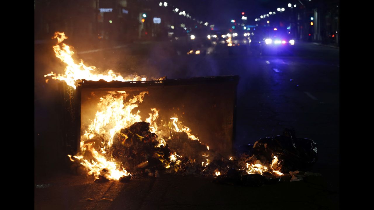 Debris burns in the street during a protest that took place in Oakland, California, after news of Trump's victory.