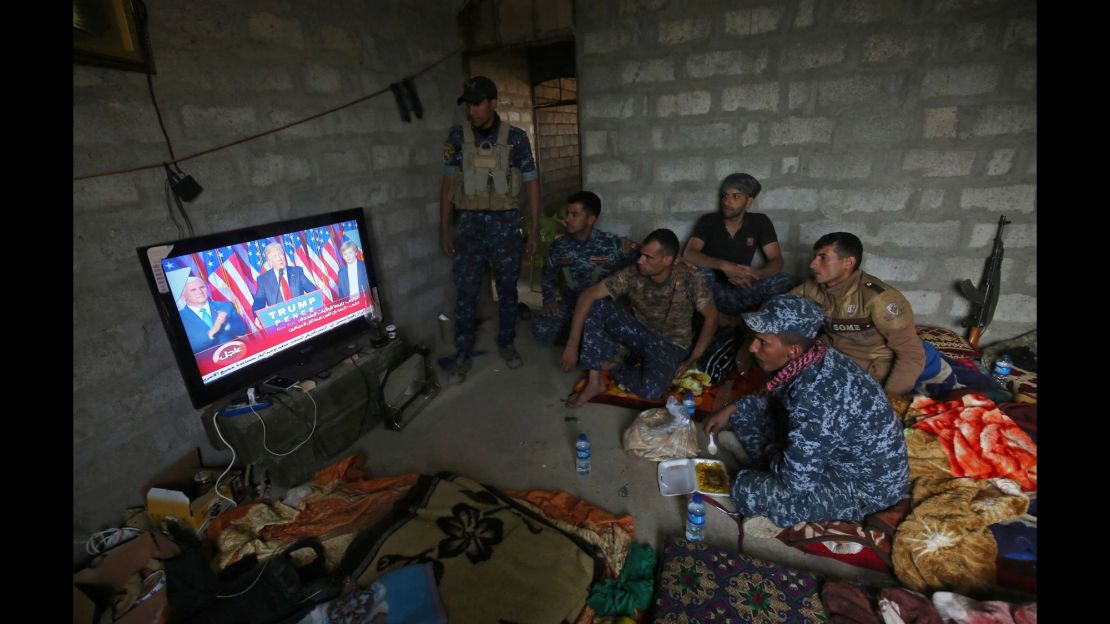 Members of the Iraqi forces in Mosul watch Donald Trump giving a speech after he won the US president elections.