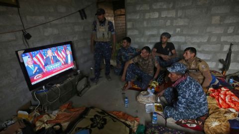 Members of the Iraqi forces in Mosul watch Donald Trump giving a speech after he won the US president elections.