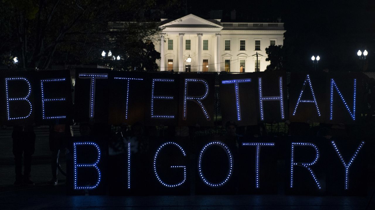 Protesters from Avaaz, a global civic movement, display a sign protesting bigotry outside the White House on Tuesday, November 8.