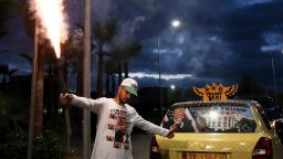 TOPSHOT - Albanian taxi driver Uljan Kolgjegja, 37 years old, holds a flare as he celebrates the victory of Republican candidate Donald Trump in the US presidential elections, in Tirana, on November 9, 2016. 
Donald Trump's extraordinary US election victory sent shockwaves across the world on November 9, 2016, as opponents braced for a "dangerous" leader in the White House while fellow populists hailed a ballot-box revolution by ordinary people. America's allies put a diplomatically brave face on the outcome of the deeply divisive presidential race, which has implications for everything from trade to human rights, climate change to global conflicts. / AFP / GENT SHKULLAKU        (Photo credit should read GENT SHKULLAKU/AFP/Getty Images)