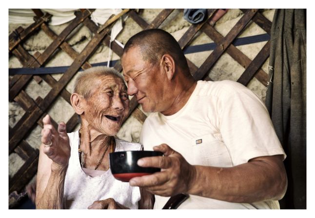 "A grandmother and grandson share a warm moment after singing traditional folk songs."