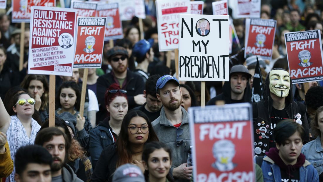 People listen to speakers protesting Trump's election in Seattle on November 9.