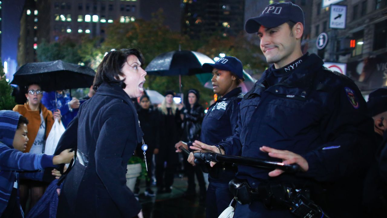 A woman argues with police officers during a protest in New York on November 9. Erin Michelle Threlfall, the woman pictured, told <a href="http://www.huffingtonpost.com/entry/5824aa40e4b0270d9a2ad89e?timestamp=1478799395467" target="_blank" target="_blank">The Huffington Post </a>she was attempting to intervene on behalf of a man she says the police were beating.