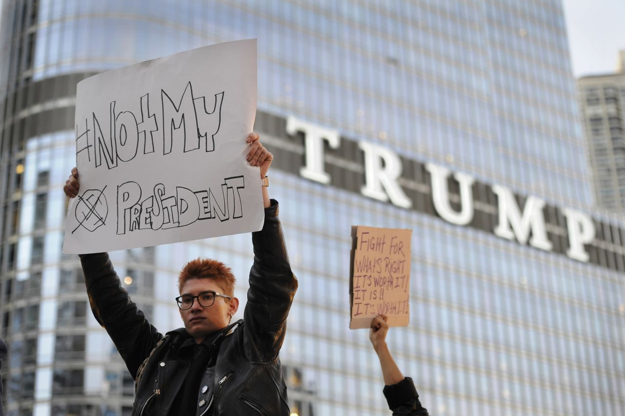 Protesters in Chicago display anti-Trump signs near the Trump International Hotel and Tower on November 9.