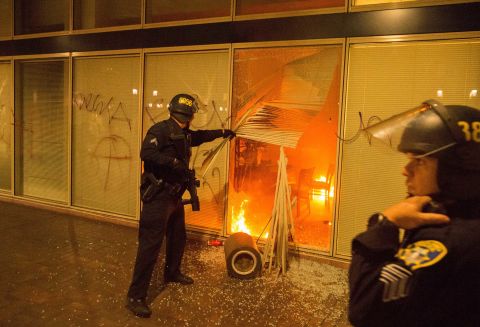 Police respond to a fire set by anti-Trump protesters in Oakland, California, on November 9. Police said some protesters threw Molotov cocktails, rocks and fireworks at officers.