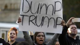 A protester holds a sign that reads "Dump Trump" as she takes part in a protest against the election of President-elect Donald Trump, Wednesday, Nov. 9, 2016, in downtown Seattle. (AP Photo/Ted S. Warren)