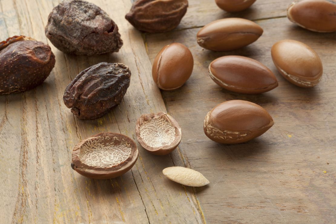 To extract the oil-rich kernels, workers first dry argan fruit, remove the fleshy pulp then crack open the hard outer case.